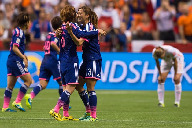 VANCOUVER, BC - JUNE 23: Mizuho Sakaguchi #6 and Rumi Utsugi #13 of Japan celebrate at the final whistle after defeating the Netherlands 2-1 during the FIFA Women's World Cup Canada 2015 Round of 16 match between the Netherlands and Japan June, 23, 2015 at BC Place Stadium in Vancouver, British Columbia, Canada.  (Photo by Rich Lam/Getty Images)