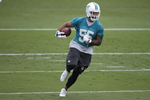 Miami Dolphins outside linebacker Koa Misi (55) runs with the football during an NFL football organized team activity, Monday, June 8, 2015, in Davie, Fla. (AP Photo/Lynne Sladky)