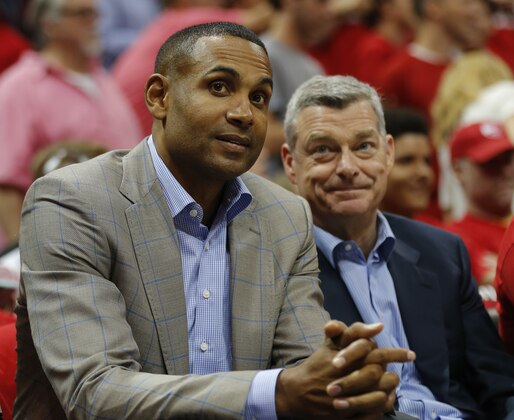 Former NBA player Grant Hill, left,  watches play during the first half in Game 1 of the Eastern Conference finals of the NBA basketball playoffs, between the Atlanta Hawks and the Cleveland Cavaliers, Wednesday, May 20, 2015, in Atlanta. (AP Photo/John Bazemore)