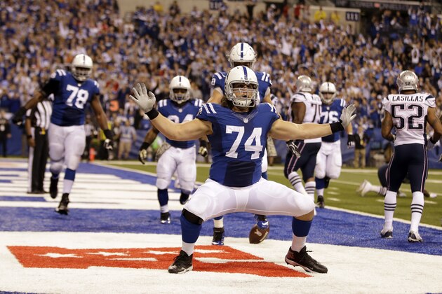 Indianapolis Colts tackle Anthony Castonzo celebrates after making a catch for a touchdown against the New England Patriots during the second half of an NFL football game in Indianapolis, Sunday, Nov. 16, 2014. (AP Photo/Darron Cummings)