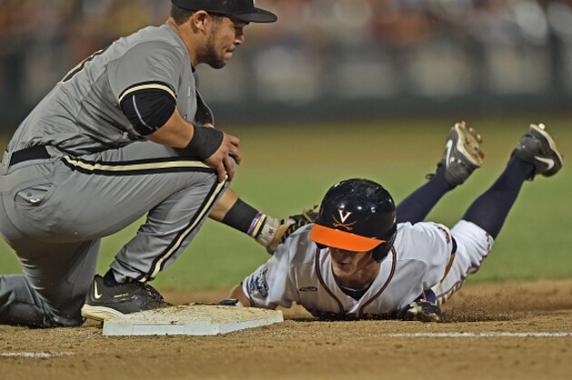 Omaha, NE - JUNE 23:  Ernie Clement #4 of the Virginia Cavaliers dives back to first base safely, before the tag from first basemen Zander Wiel #43 of the Vanderbilt Commodores in the eighth inning during game two of the College World Series Championship Series on June 23, 2015 at TD Ameritrade Park in Omaha, Nebraska.  (Photo by Peter Aiken/Getty Images)