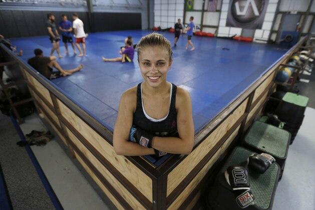 In this Monday, April 13, 2015, photo, mixed martial arts fighter Paige VanZant  poses after her workout at the Ultimate Fitness gym in Sacramento, Calif. VanZant, 21, will fight Felice Herrig in an Ultimate Fighting Championship strawweight match, in New Jersey on Saturday. (AP Photo/Rich Pedroncelli)