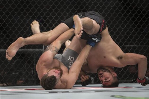 Nate Marquardt, left, battles against Kelvin Gastelum during a men's middleweight UFC 188 mixed martial arts bout in Mexico City, Saturday, June  13, 2015. Gastelum won the fight by submission. (AP Photo/Christian Palma)