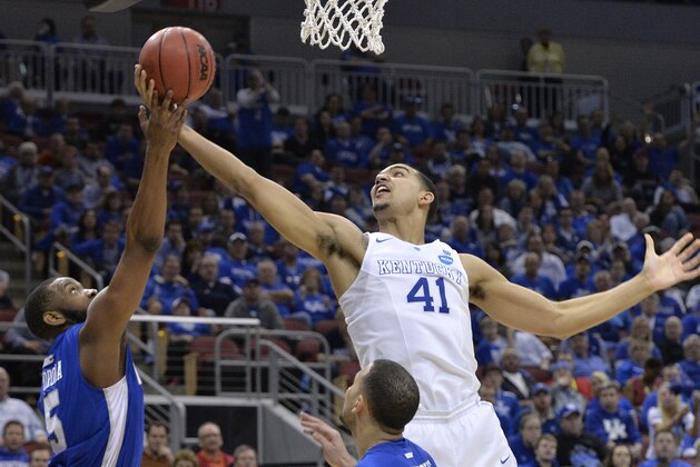 Kentucky's Trey Lyles, right, fights for a rebound with Hampton's Emmanuel Okoroba during the second half of an NCAA tournament second round college basketball game in Louisville, Ky., Friday, March 20, 2015. Kentucky won 79-56. (AP Photo/Timothy D. Easley)