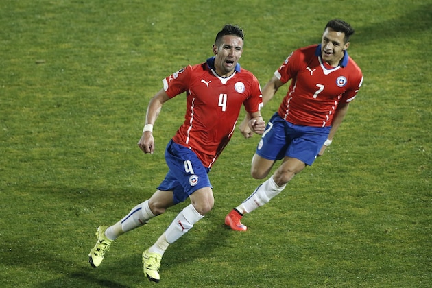 Chile's Mauricio Isla, left, celebrates after scoring against Uruguay with teammate Chile's Alexis Sanchez, right, during a Copa America quarterfinal soccer match at the National Stadium in Santiago, Chile, Wednesday, June 24, 2015. Chile won the match 1-0. (AP Photo/Silvia Izquierdo)