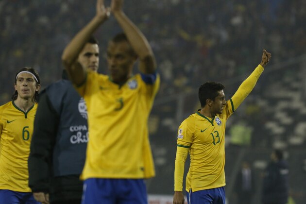 Brazil' Miranda, center, Marquinhos, right, and Felipe Luis acknowledge the crowd as they leave the pitch with their teammates at the end of a match against Venezuela, during a Copa America Group C soccer match at the Monumental stadium in Santiago, Chile, Sunday, June 21, 2015. Brazil won the match 2-1. (AP Photo/Luis Hidalgo)