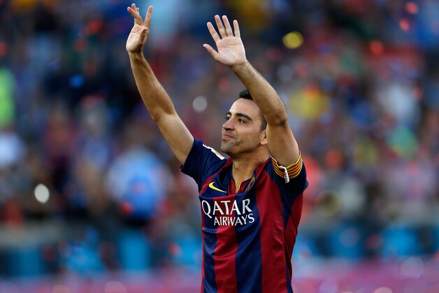 FC Barcelona's Xavi Hernandez waves to supporters after winning the Spanish League title, at the end of their Spanish La Liga last round soccer match against Deportivo Coruna at the Camp Nou stadium in Barcelona, Spain, Saturday, May 23, 2015. Hernandez says he will leave the Catalan club after 17 trophy-laden seasons in which he set club records for appearances and titles won. (AP Photo/Manu Fernandez)