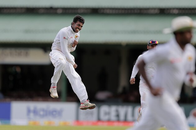 Sri Lanka's Tharindu Kaushal, left, jumps as he celebrates taking five wickets during the first day of the second test cricket match against Pakistan in Colombo, Sri Lanka, Thursday, June 25, 2015. (AP Photo/Eranga Jayawardena)