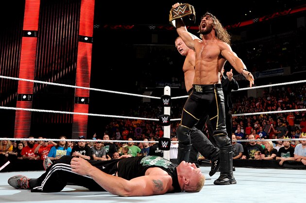 Seth Rollins standing over Brock Lesnar.