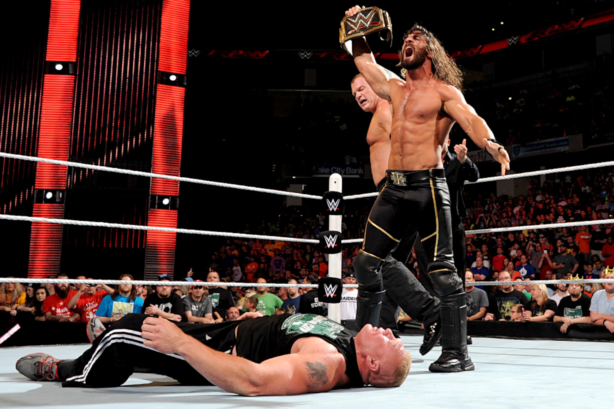 Seth Rollins standing over Brock Lesnar.