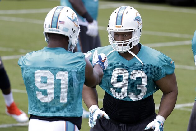 Miami Dolphins defensive end Cameron Wake (91) and defensive tackle Ndamukong Suh (93) do drills during an NFL football organized team activity, Monday, June 1, 2015, in Davie, Fla. (AP Photo/Lynne Sladky)