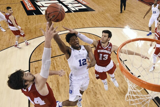 Duke's Justise Winslow (12) goes up for a shot between Wisconsin's Frank Kaminsky (44) and Duje Dukan (13) during the first half of the NCAA Final Four college basketball tournament championship game Monday, April 6, 2015, in Indianapolis. (AP Photo/Chris Steppig, Pool) Duke's Justise Winslow (12) goes up for a shot between Wisconsin's Frank Kaminsky (44) and Duje Dukan (13) during the first half of the NCAA Final Four college basketball tournament championship game Monday, April 6, 2015, in Indianapolis. (AP Photo/Chris Steppig, Pool)