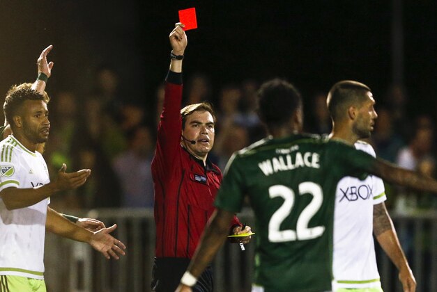 Jun 16, 2015; Tukwila, WA, USA; Referee Daniel Radford issues a red card to Seattle Sounders FC forward Clint Dempsey (2, right) during the second half of overtime against the Portland Timbers at Starfire Sports Complex. Portland defeated Seattle, 3-1, in overtime. Mandatory Credit: Jennifer Buchanan-USA TODAY Sports