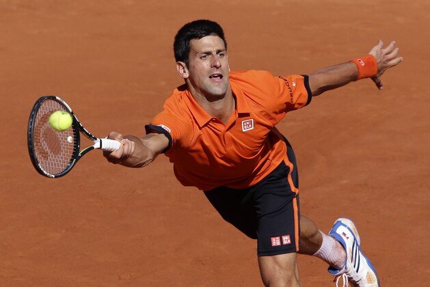 Serbia's Novak Djokovic returns in the men's final of the French Open tennis tournament against Switzerland's Stan Wawrinka at the Roland Garros stadium, in Paris, France, Sunday, June 7, 2015. (AP Photo/Thibault Camus)