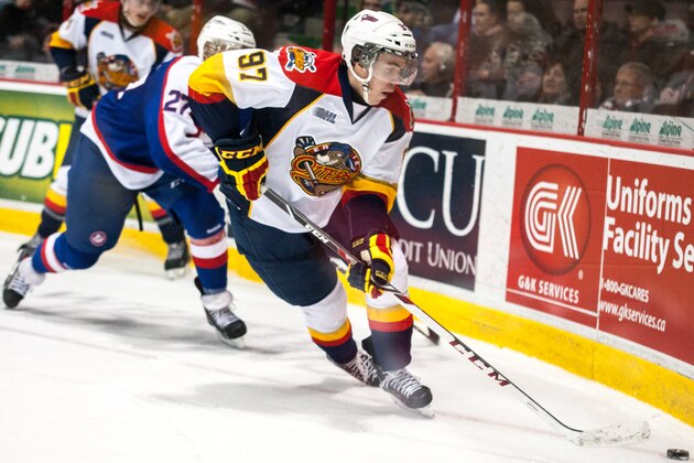 WINDSOR, ON - MARCH 13: Connor McDavid #97 of the Erie Otters moves the puck against Eric Diodati #27 of the Windsor Spitfires on March 13, 2014 at the WFCU Centre in Windsor, Ontario, Canada. (Photo by Dennis Pajot/Getty Images)