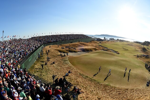UNIVERSITY PLACE, WA - JUNE 21:  Dustin Johnson of the United States and Jason Day of Australia walk off the 18th green with their caddies during the final round of the 115th U.S. Open Championship at Chambers Bay on June 21, 2015 in University Place, Washington.  (Photo by Harry How/Getty Images)