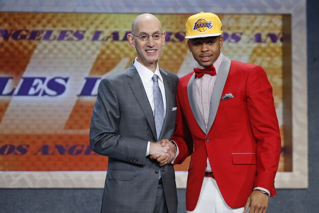 D’Angelo Russell, right, poses for a photo with NBA Commissioner Adam Silver after the Los Angeles Lakers selected Russell with the second pick during the NBA basketball draft, Thursday, June 25, 2015, in New York. (AP Photo/Kathy Willens)