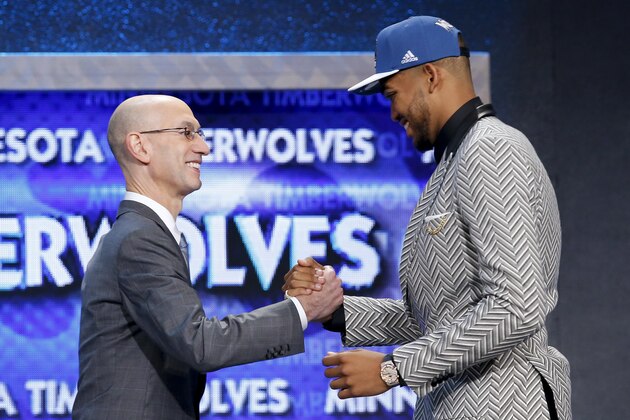 Karl-Anthony Towns, right, is greeted by NBA Commissioner Adam Silver after being announced as the top pick, by the Minnesota Timberwolves, at the NBA basketball draft Thursday, June 25, 2015, in New York. (AP Photo/Kathy Willens)