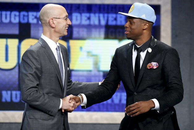 Emmanuel Mudiay, right,is greeted by NBA Commissioner Adam Silver after being selected seventh overall by the Denver Nuggets during the NBA basketball draft, Thursday, June 25, 2015, in New York. (AP Photo/Kathy Willens)