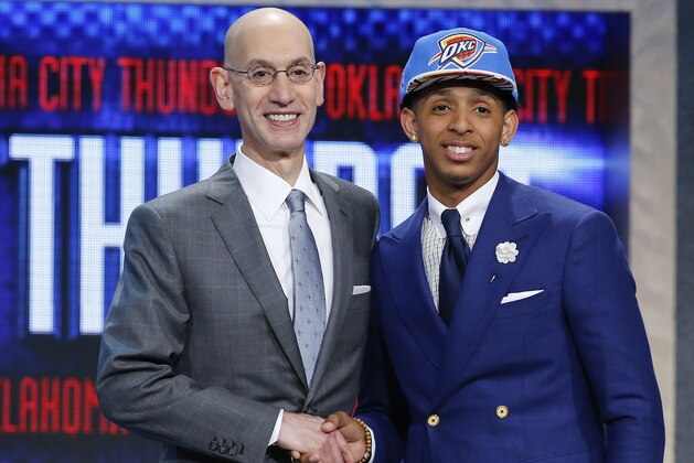 Cameron Payne, right, poses for photos with NBA Commissioner Adam Silver after being selected 14th overall by the Oklahoma City Thunder during the NBA basketball draft, Thursday, June 25, 2015, in New York. (AP Photo/Kathy Willens)