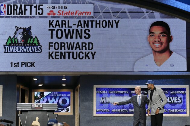 Karl-Anthony Towns, right, is directed off stage by NBA Commissioner Adam Silver after being selected first overall by the Minnesota Timberwolves during the NBA basketball draft, Thursday, June 25, 2015, in New York. (AP Photo/Julie Jacobson)