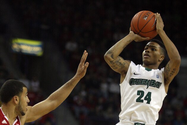 Nov 16, 2013; Green Bay, WI, USA; Wisconsin Green Bay Phoenix guard Keifer Sykes (24) attempts a basket as Wisconsin Badgers guard Traevon Jackson (12) defends  at the Resch Center in Ashwaubenon. Mandatory Credit: Mary Langenfeld-USA TODAY Sports