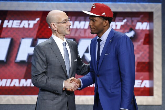 Justise Winslow, right is greeted by NBA commissioner Adam Silver after being selected 10th overall by the Miami Heat during the NBA basketball draft, Thursday, June 25, 2015, in New York. (AP Photo/Kathy Willens)