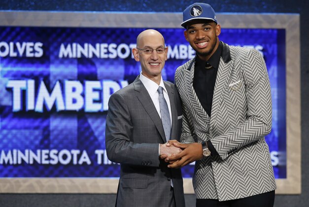 Karl-Anthony Towns, right, poses for a photo with NBA Commissioner Adam Silver after being announced as the top pick during the NBA basketball draft by the Minnesota Timberwolves, Thursday, June 25, 2015, in New York. (AP Photo/Kathy Willens)