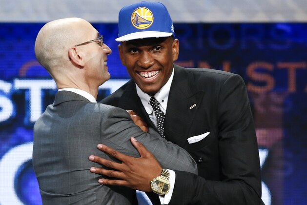 Kevon Looney, right, greets NBA Commissioner Adam Silver after being selected 30th overall by the Golden State Warriors during the NBA basketball draft, Thursday, June 25, 2015, in New York. (AP Photo/Kathy Willens)