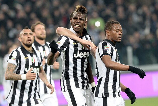 Juventus' Paul Pogba, foreground, celebrates with his teammates after scoring during a Serie A soccer match between Juventus and Sassuolo at the Juventus stadium, in Turin, Italy, Monday, March 9, 2015. Juventus won 1-0. (AP Photo/Massimo Pinca)