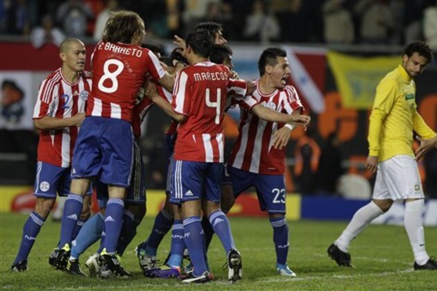 Paraguay's players celebrate after Brazil's Fred, right, missed to score the decisive penalty kick in the penalty shootout during a Copa America quarterfinal soccer match in La Plata, Argentina, Sunday, July 17, 2011. Paraguay advanced to the semifinals after beating Brazil 2-0 on penalties. (AP Photo/Eduardo Di Baia)
