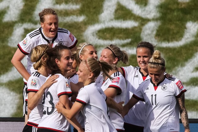 OTTAWA, ON - JUNE 7: Melanie Behringer #7 of Germany jumps to celebrate a goal with her teammates including Sara Dabritz #23 and Anja Mittag #11 during the FIFA Women's World Cup Canada 2015 Group B match between Germany and Cote d'Ivoire at Lansdowne Stadium on June 7, 2015 in Ottawa, Canada.  (Photo by Andre Ringuette/Getty Images)