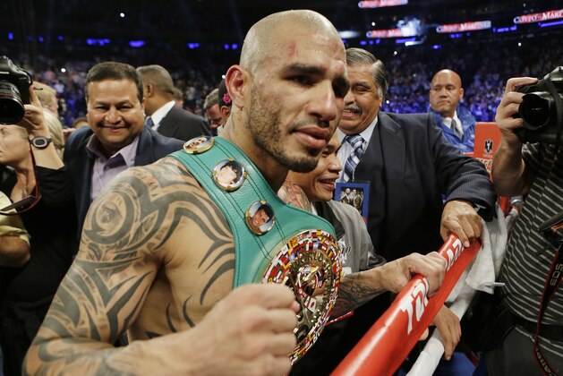 Miguel Cotto, of Puerto Rico, reacts after winning a WBC World Middleweight Title boxing match against Sergio Martinez, of Argentina, Sunday, June 8, 2014, in New York.  Cotto won by technical knockout after the ninth round. (AP Photo/Frank Franklin II)