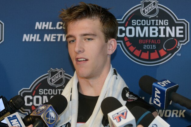 Noah Hanifin talks with reporters after he completed his hockey testing at the NHL Combine, Saturday, June 6, 2015, in Buffalo, N.Y. (AP Photo/Gary Wiepert)