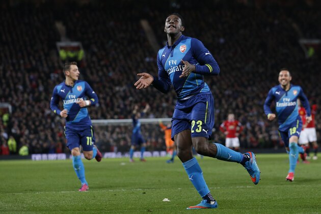 Arsenal's Danny Welbeck  celebrates after scoring his side second goal during the English FA Cup quarterfinal soccer match between Manchester United and Arsenal at Old Trafford Stadium, Manchester, England, Monday, March 9, 2015. (AP Photo/Jon Super)