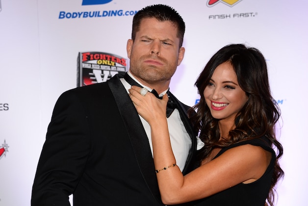LAS VEGAS, NV - FEBRUARY 07:  Co-hosts Brian Stann (L) and Nicole Dabeau joke around as they arrive at the sixth annual Fighters Only World Mixed Martial Arts Awards at The Palazzo Las Vegas on February 7, 2014 in Las Vegas, Nevada.  (Photo by Ethan Miller/Getty Images)