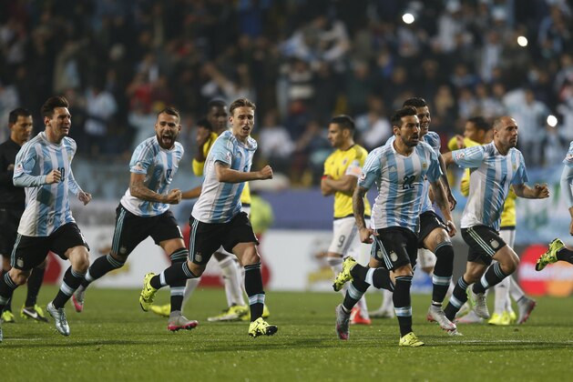 Argentina's players celebrate after Carlos Tevez scored the winning penalty kick  during a Copa America quarterfinal soccer match against Colombia  at the Sausalito Stadium in Vina del Mar, Chile, Friday, June 26, 2015. (AP Photo/Andre Penner)