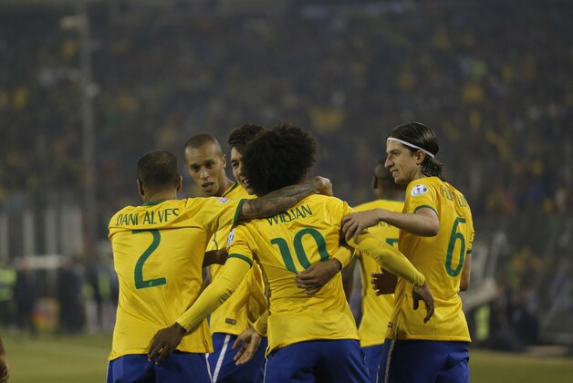 Brazil's players celebrate after scoring their second goal during a Copa America Group C soccer match against Venezuela at the Monumental stadium in Santiago, Chile, Sunday, June 21, 2015. Brazil won the match 2-1.(AP Photo/Silvia Izquierdo)