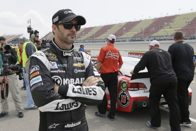 Jimmie Johnson waits on pit row before qualifying for Sunday's NASCAR Sprint Cup series auto race at Michigan International Speedway, Friday, June 12, 2015, in Brooklyn, Mich. (AP Photo/Carlos Osorio)
