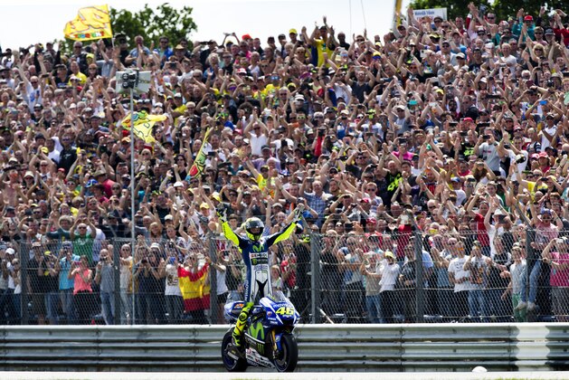 Valentino Rossi celebrates on his Yamaha after winning the Dutch MotoGP Grand Prix, in Assen, northern Netherlands, Saturday, June 27, 2015. (AP Photo/Vincent Jannink)