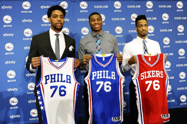 Philadelphia 76ers NBA draft picks Jahlil Okafor, left, Richaun Holmes, center, and J.P. Tokoto hold up jerseys during a press conference at the 76ers practice facility, Saturday, June 27, 2015, in Philadelphia. (AP Photo/Michael Perez)