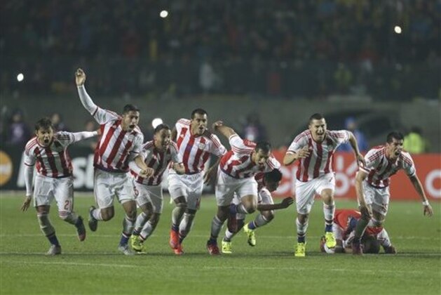 Paraguay's players celebrate after scoring the winning penalty kick  during a Copa America quarterfinal soccer match at the Ester Roa Rebolledo Stadium in Concepcion, Chile, Saturday, June 27, 2015. (AP Photo/Natacha Pisarenko)