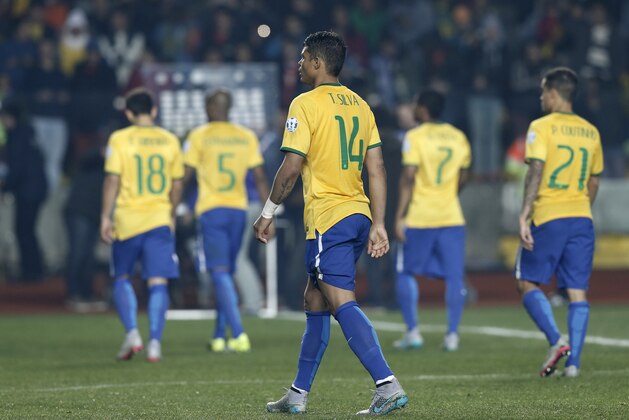 Brazil's Thiago Silva and his teammates leave the pitch after being defeated by Paraguay in a Copa America quarterfinal soccer match at the Ester Roa Rebolledo Stadium in Concepcion, Chile, Saturday, June 27, 2015. Paraguay defeated Brazil 4-3 in a penalty shoot out after the game ended in a 1-1 draw. (AP Photo/Silvia Izquierdo)