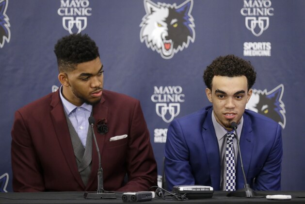 Minnesota Timberwolves draft pick Tyus Jones, right, responds to a question as fellow pick Karl-Anthony Towns, left, listens, during an NBA basketball news conference in Minneapolis, Friday, June 26, 2015.  Towns was the No. 1 overall pick, while Jones was selected 24th, in the NBA draft the night before. (AP Photo/Ann Heisenfelt)
