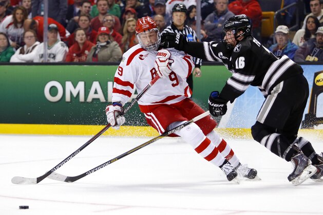 Apr 11, 2015; Boston, MA, USA; Providence College Friars defenseman Anthony Florentino (16) tries to knock Boston University Terriers forward Jack Eichel (9) off the puck during the first period of the championship game of the Frozen Four college ice hockey tournament at TD Garden. Mandatory Credit: Winslow Townson-USA TODAY Sports