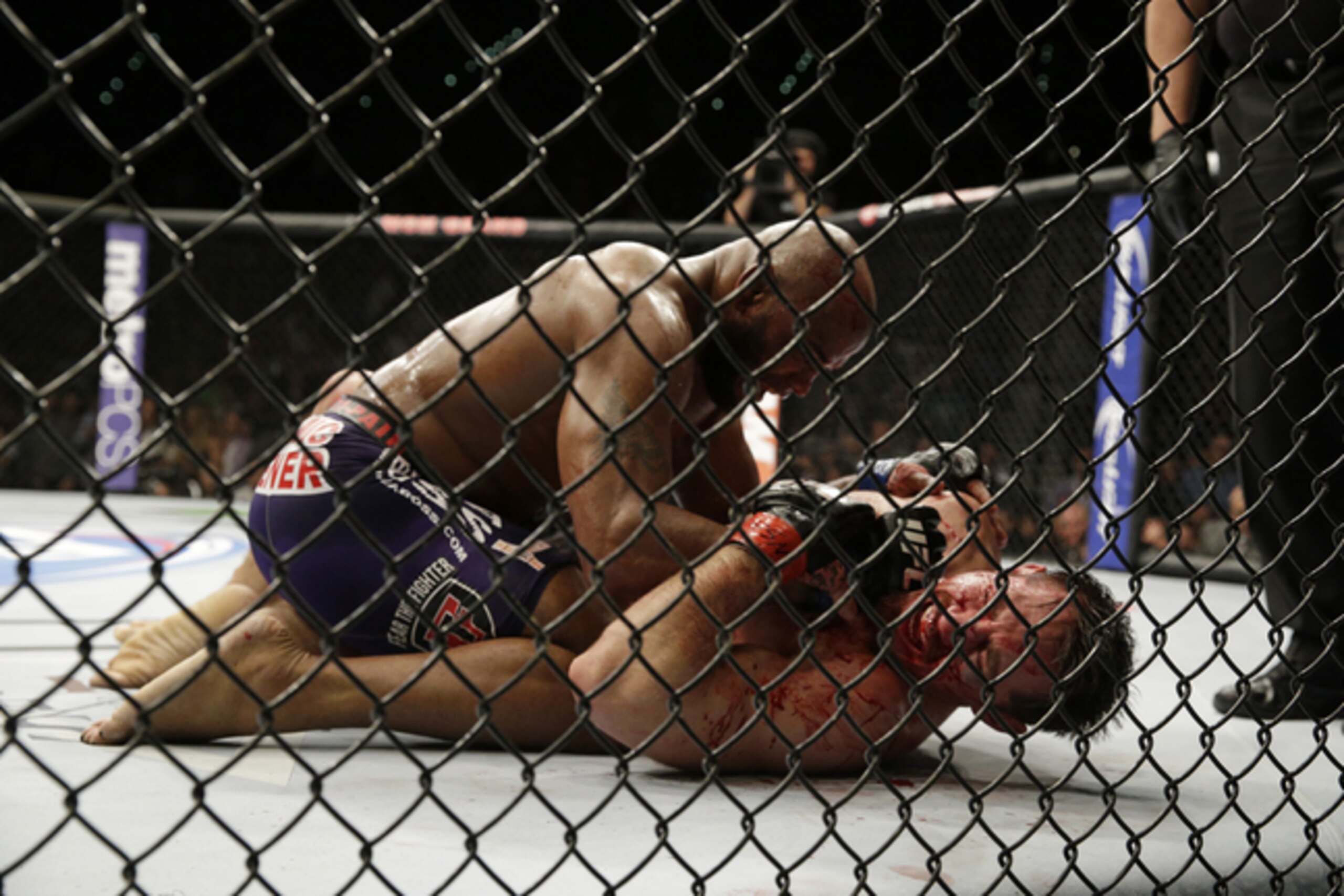 Yoel Romero, top, pins Tim Kennedy during their fight, Saturday, Sept. 27, 2014, in Las Vegas. Romero won via TKO. (AP Photo/John Locher)