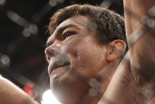 Lyoto Machida, from Brazil, celebrates after defeating CB Dollaway, from the United States, during their UFC middleweight mixed martial arts bout in Barueri, on the outskirts of Sao Paulo, Brazil, early Sunday, Dec. 21, 2014. (AP Photo/Andre Penner)