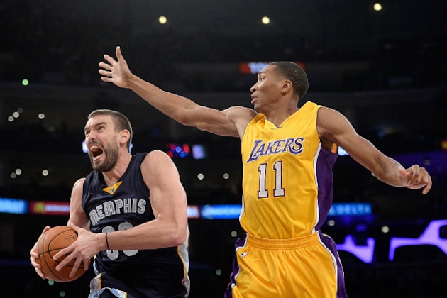 LOS ANGELES, CA - NOVEMBER 26:  Marc Gasol #33 of the Memphis Grizzlies drives to the basket under the arm of Wesley Johnson #11 of the Los Angeles Lakers during a 99-93 Grizzlies win at Staples Center on November 26, 2014 in Los Angeles, California.  NOTE TO USER: User expressly acknowledges and agrees that, by downloading and or using this Photograph, user is consenting to the terms and condition of the Getty Images License Agreement.  (Photo by Harry How/Getty Images)