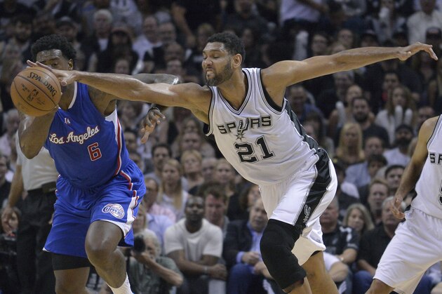 San Antonio Spurs' Tim Duncan (21) tries to steal the ball from Los Angeles Clippers' DeAndre Jordan (6) during the first half of Game 6 in an NBA basketball first-round playoff series, Thursday, April 30, 2015, in San Antonio. (AP Photo/Darren Abate)
