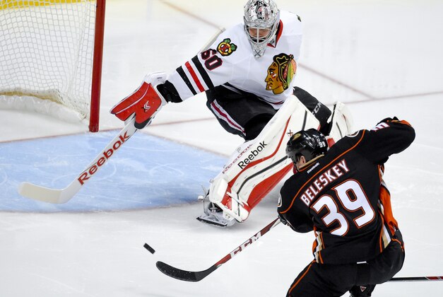 Anaheim Ducks left wing Matt Beleskey right, scores the game winning goal past Chicago Blackhawks goalie Corey Crawford during overtime in Game 5 of the Western Conference final of the NHL hockey Stanley Cup playoffs in Anaheim, Calif., on Monday, May 25, 2015.  (AP Photo/Mark J. Terrill)